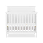 Ava 4-in-1 Convertible Mini Crib in White, Greenguard Gold Certified, Non-Toxic Finish, Comes with 1" Mattress Pad, with 3 Mattress Height Settings