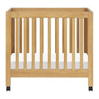 Babyletto Origami Mini Portable Crib Folding with Wheels in Honey, 2 Adjustable Mattress Positions, Greenguard Gold Certified